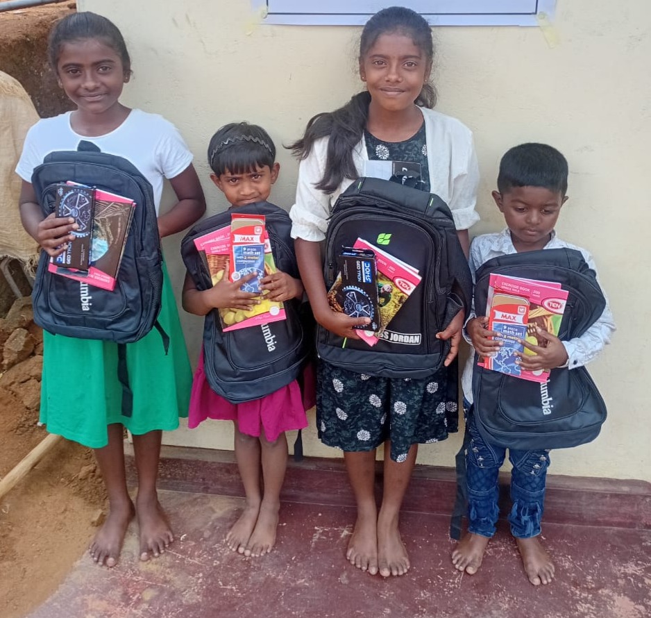 Students receiving school bags and supplies